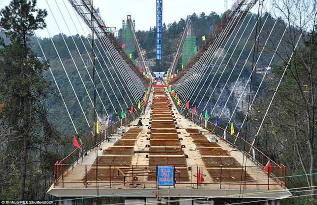 The nail-biting structure, which is between two cliffs in the national park of Zhangjiajie, is set to open to bold tourists in July