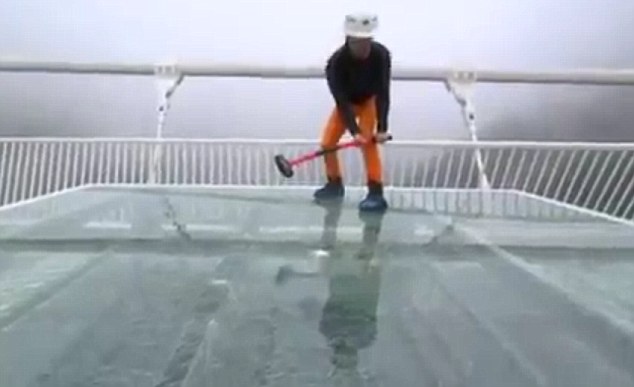 A journalist has tested the safety of a 430m glass bridge by slamming it with a sledgehammer